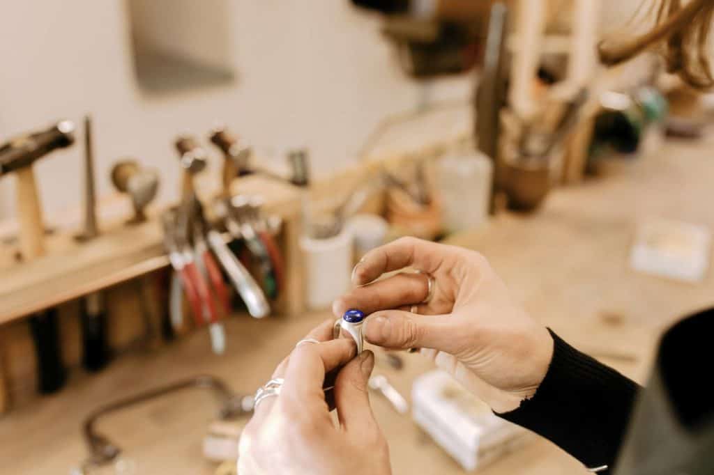 close up of hands holding a ring in a jewellery studio